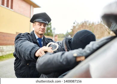 policeman-arresting-burglar-handcuffs-260nw-1400087156